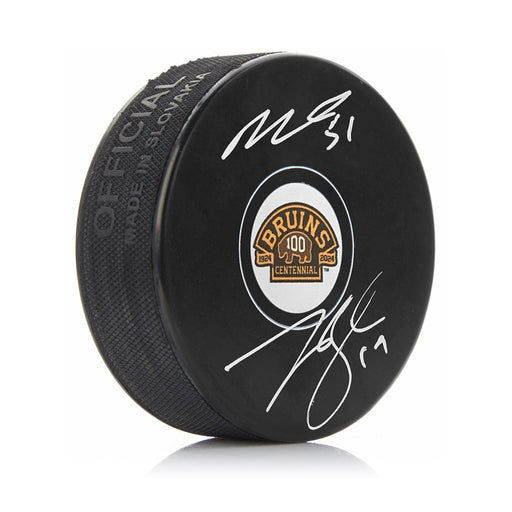 Matthew Poitras & Johnny Beecher Autographed Boston Bruins 100th Anniversary Hockey Logo Puck - for just $159.99! 